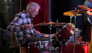 Arthur playing the drums.